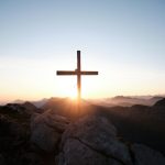 brown cross on brown rock during daytime